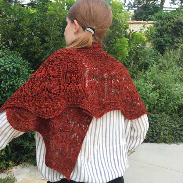 model wearing dark red Feuille-morte shawl wrapped around shoulders, closeup of twisted stitch lace texture