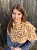 speckled Feuille-morte shawl wrapped around model's shoulders, detail of stitch texture in finer gauge yarn