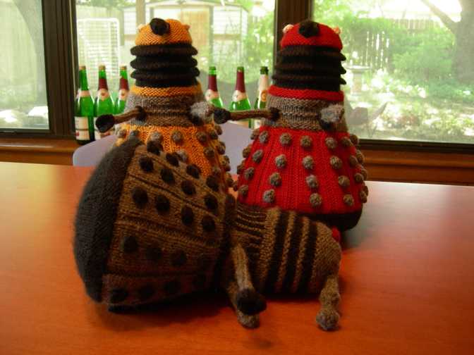 New Paradigm Daleks with old-style Dalek lying on its side