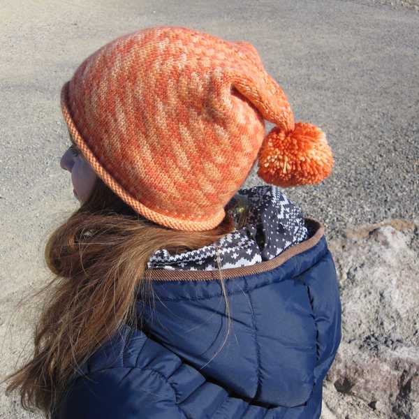 side view of orange Electricity hat detailing the drape and subtle stitch definition