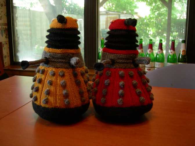 New Paradigm Daleks, one orange, one red